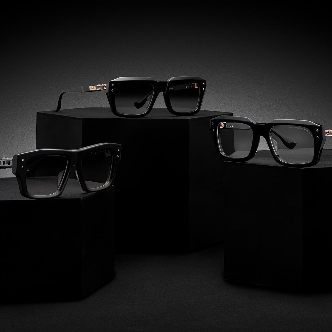 Three pairs of stylish black square-framed glasses are displayed on matte black pedestals against a dark gradient background, creating a sleek and modern feel.