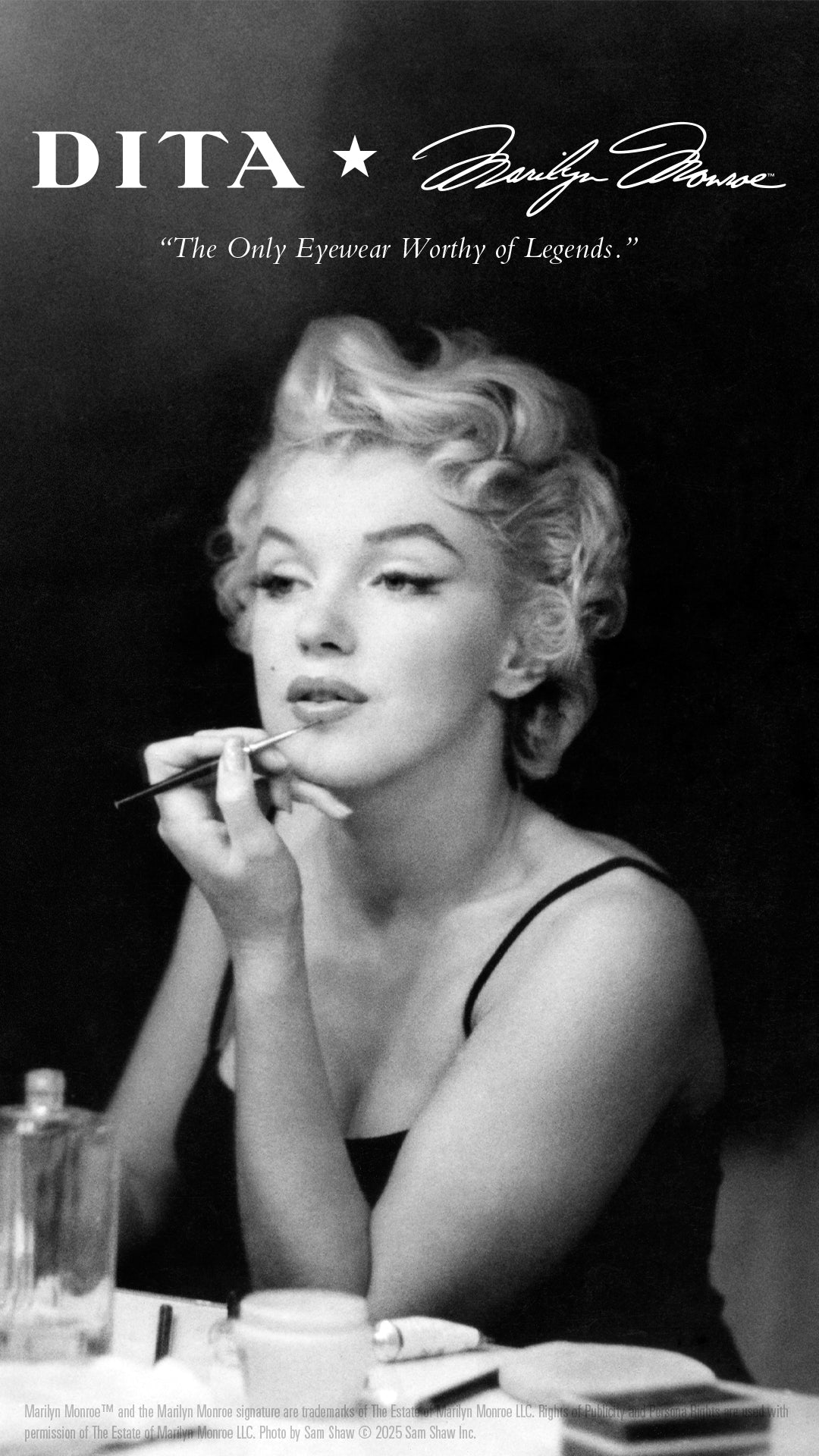 In a classic black-and-white photo, Marilyn Monroe elegantly applies makeup at a vanity. The ad features DITA eyewear with a quote: The Only Eyewear Worthy of Legends.